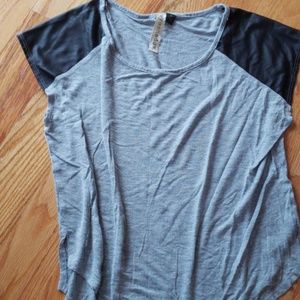Grey shirt with leather like material on the sleev